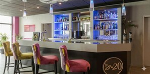 A bar area with a counter, bar stools, shelves with bottles, and a logo on the counter. - Relais St Eloi, Sure Hotel Collection by Best Western (Tours)