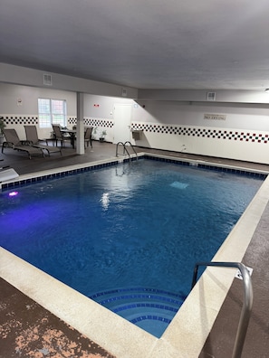 Swim and relax in our indoor pool surrounded by comfortable lounge chairs and a small table.