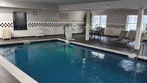 A swimming pool with a lifeguard chair, a sign warning of no lifeguard on duty, and a checkered wall pattern. - Country Inn & Suites by Radisson, Elgin, IL (Elgin)