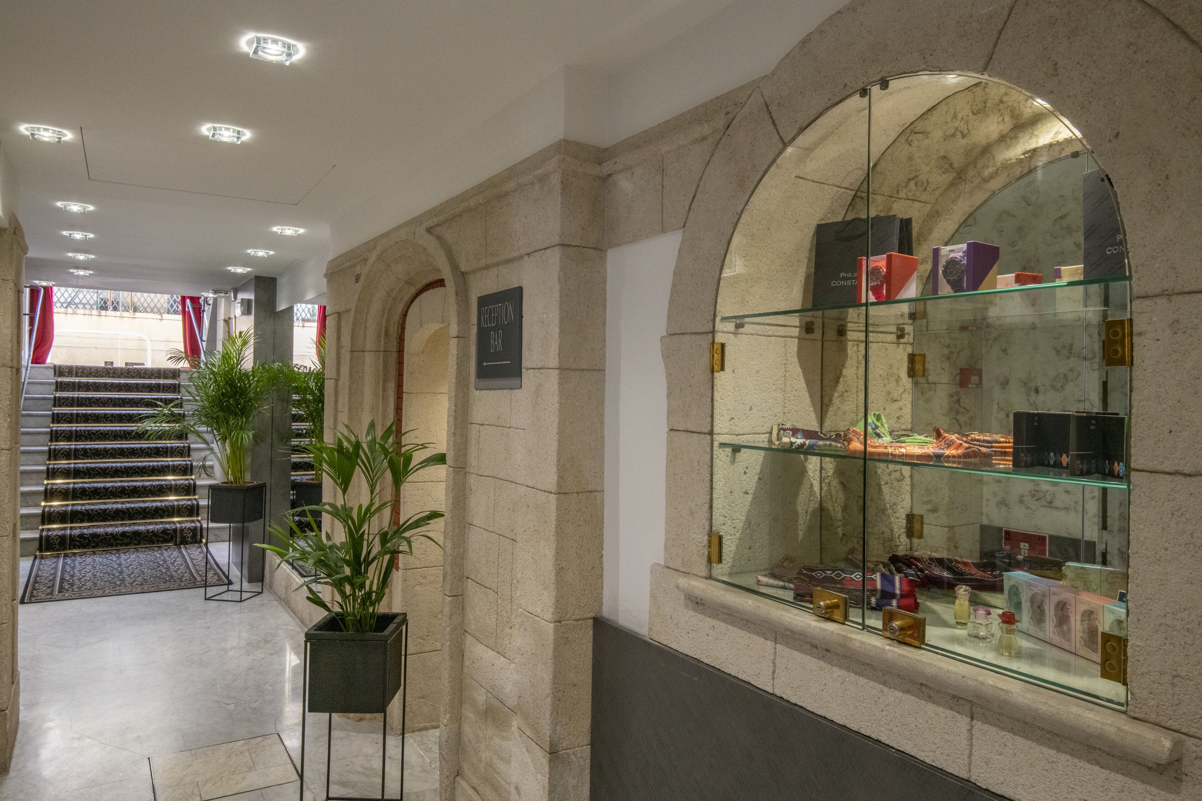 A reception area with a glass display case containing various items.