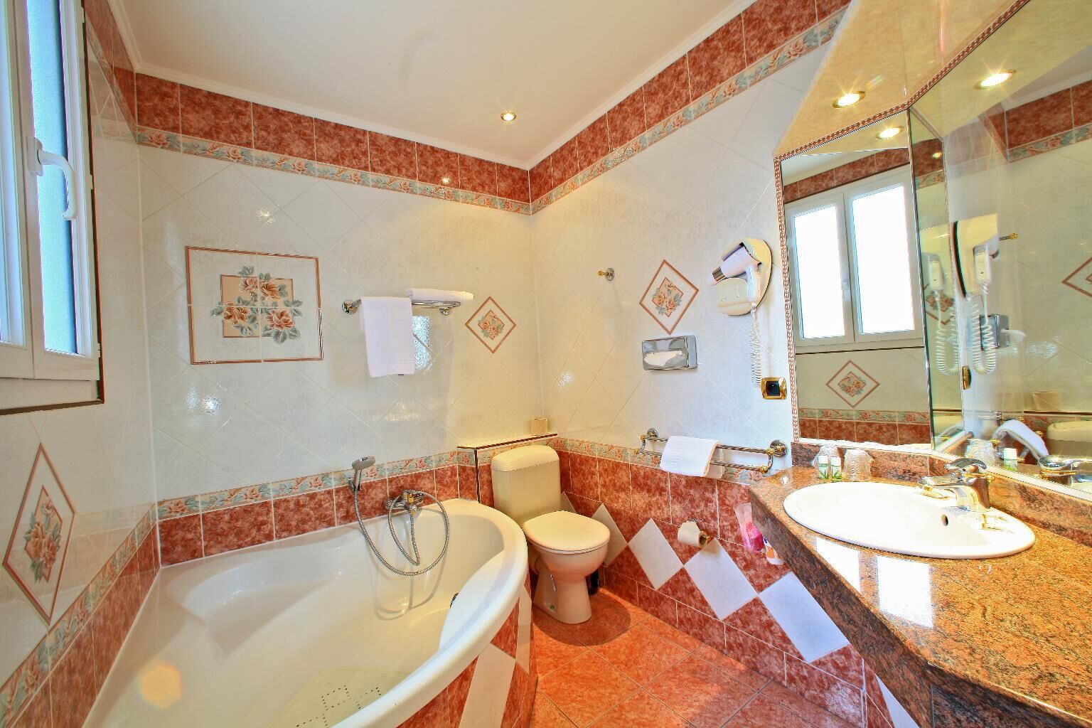 A bathroom with a bathtub, toilet, and sink.