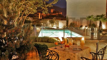 Seasonal outdoor pool, open 10:00 AM to 8:00 PM, pool umbrellas