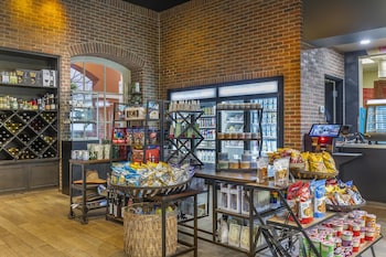 A spacious indoor area with a high ceiling, metal beams, and a counter with bar stools. at Hilton Grand Vacations Club SeaWorld® Orlando