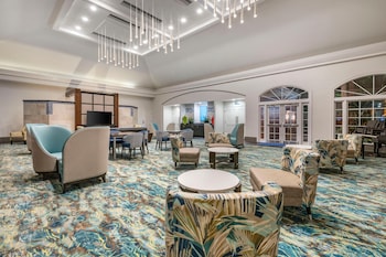 A kitchen with wooden cabinets, stainless steel appliances, and a granite countertop. at Hilton Grand Vacations Club SeaWorld® Orlando