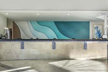 A park with a blue canopy, a playground, and a bench. at Hilton Grand Vacations Club SeaWorld® Orlando