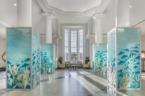 A spacious lobby with high ceilings, large windows, and a central seating area. - Hilton Grand Vacations Club SeaWorld® Orlando (Orlando)