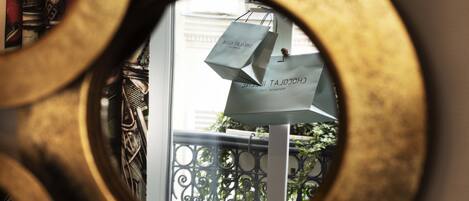 A view through a circular window with a shopping bag hanging on a railing.
