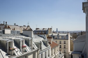 A view of a densely packed urban area with multiple buildings, including residential and commercial structures.