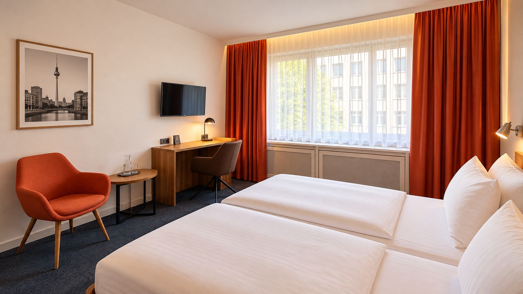 A hotel room with a bed, a desk, a chair, a TV, and a window with curtains.