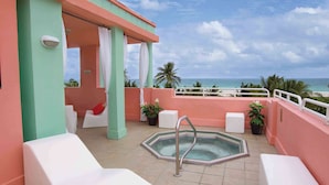 A rooftop terrace with a pool, white lounge chairs, and a view of the ocean. - Hilton Vacation Club Crescent on South Beach Miami (Miami Beach)