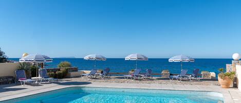 Seasonal outdoor pool, open 9:30 AM to 6:00 PM, pool umbrellas