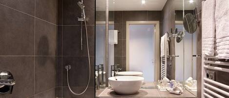 Un baño moderno con una bañera, un espejo grande y un tocador con lavamanos.