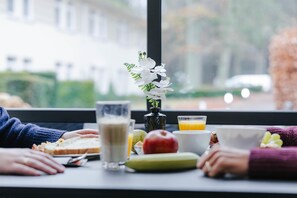 A breakfast table with food, drinks, and a vase of flowers. - Radisson Blu Balmoral Hotel, Spa (Spa)