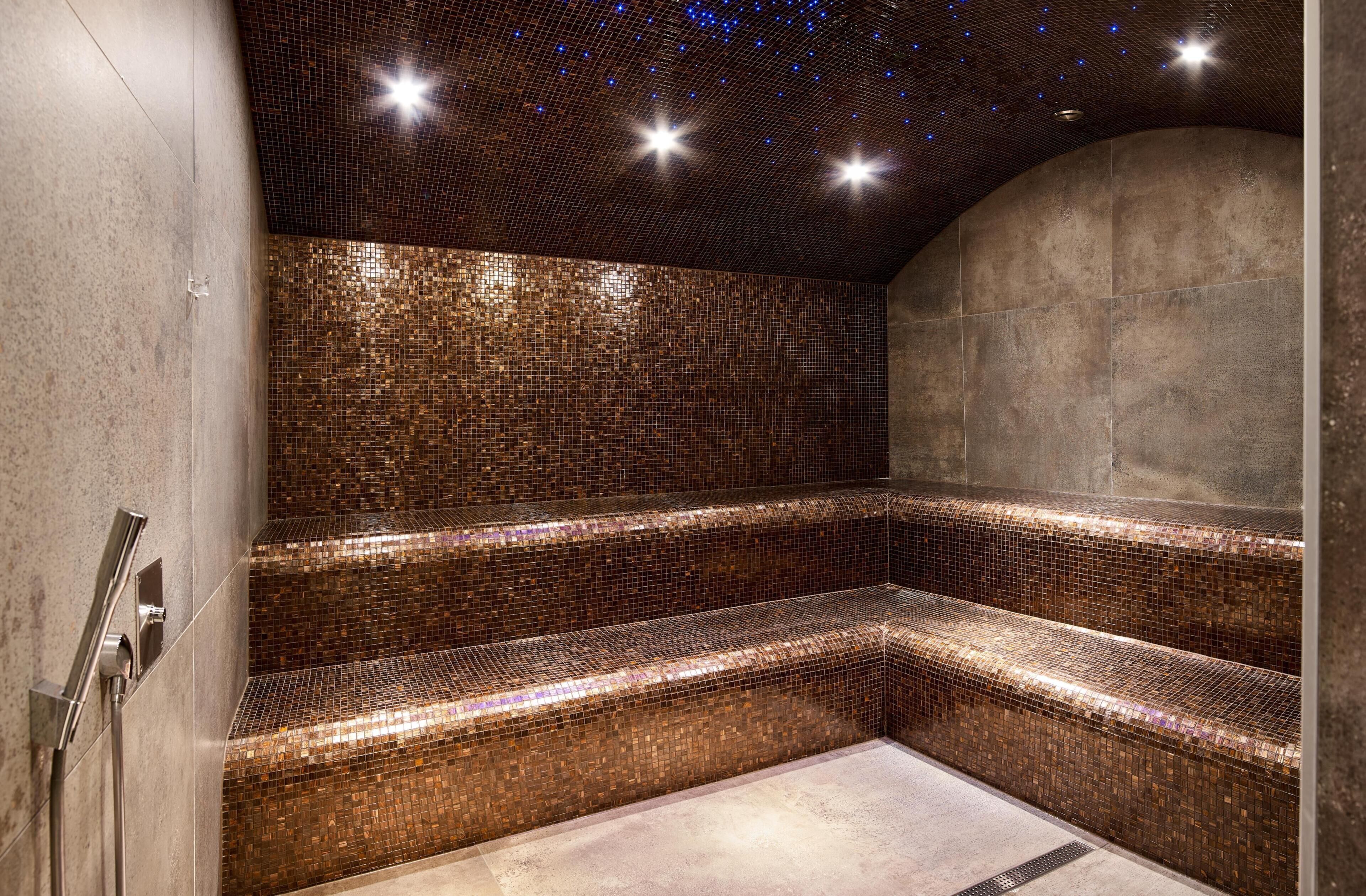 A modern spa with a mosaic-tiled wall and a curved ceiling.