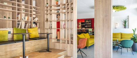 A modern interior with a wooden bookshelf, seating area, and a bar.