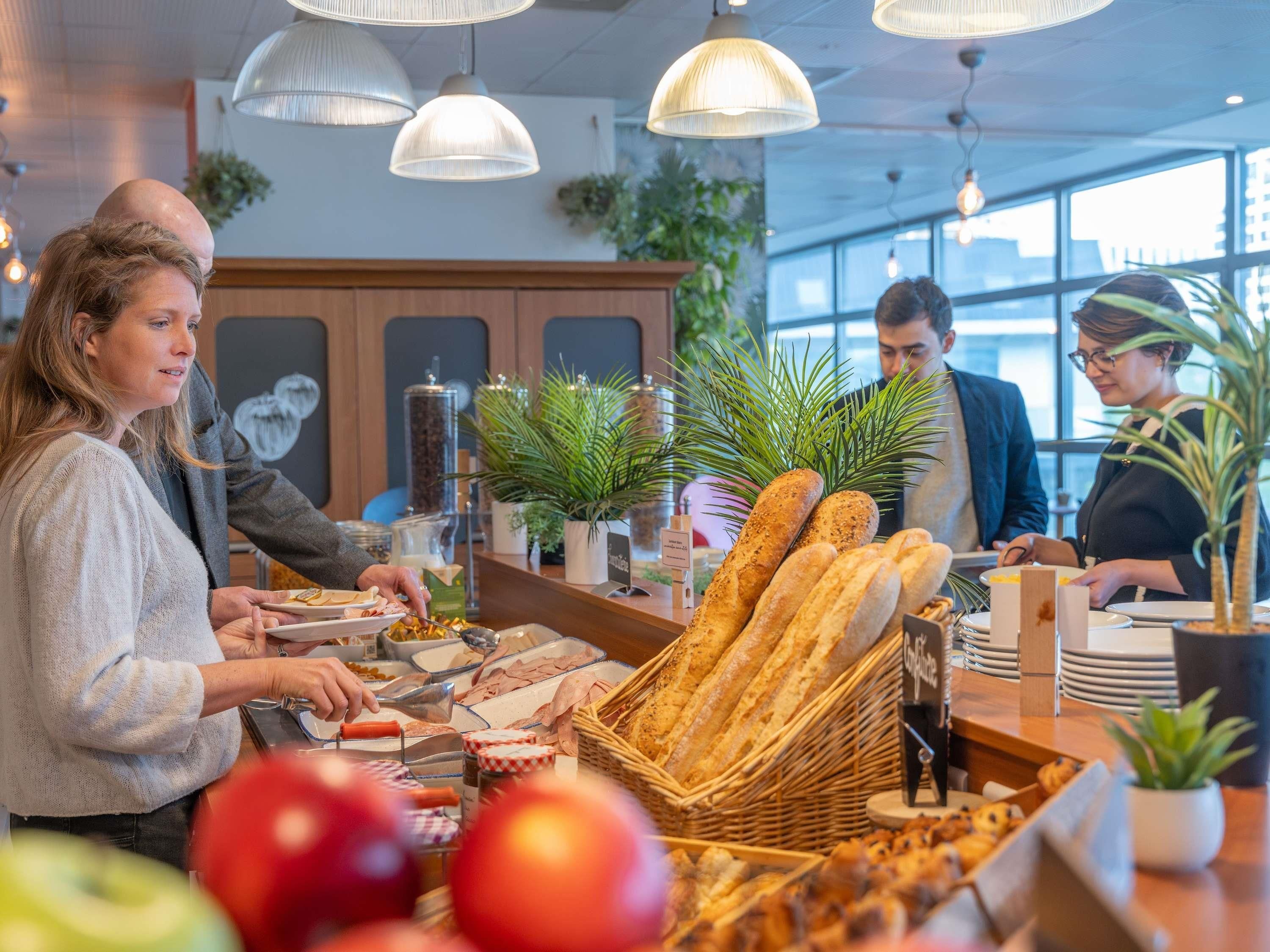 A breakfast buffet with various food items and bread.