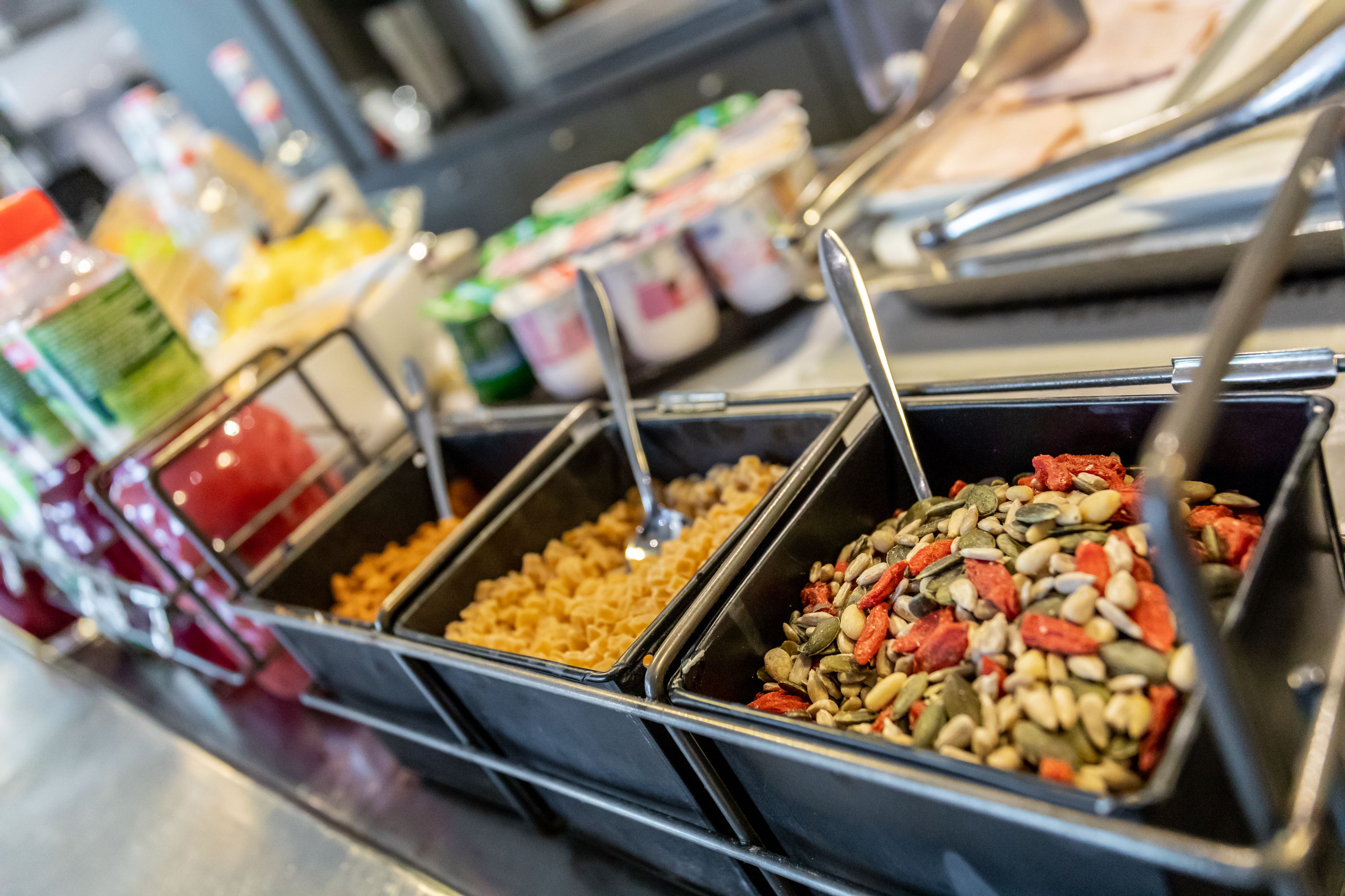 A buffet with various food options including nuts, seeds, and grains.