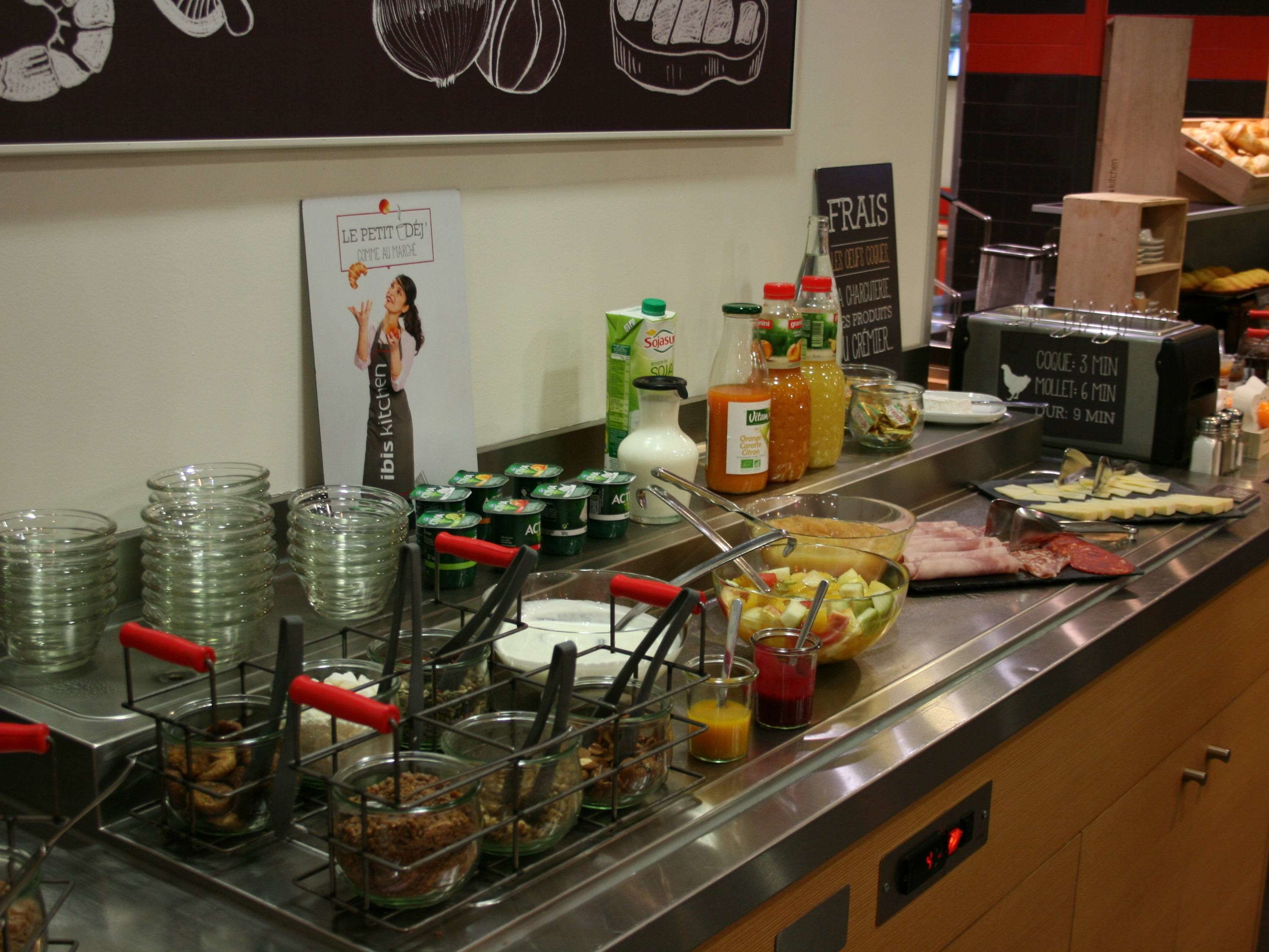 A buffet setup with various food items and condiments.