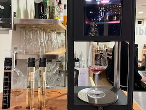 A wine display with bottles, glasses, and a wine tasting station.