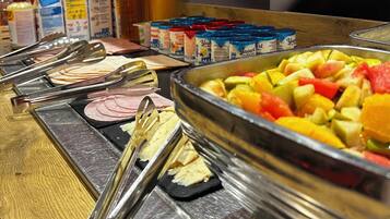 Un buffet proposant une variété de plats, d’ustensiles et de condiments.