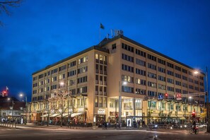 A multi-story hotel with a flat facade, large windows, and a flag on top.
