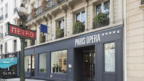 A Paris Opera building with a large entrance and a 'METRO' sign nearby. - Hotel Paris Opera Affiliated by Meliá (Paris)