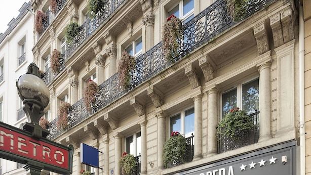 A Paris Opera building facade with ornate balconies, large windows, and a metro sign. - Hotel Paris Opera Affiliated by Meliá (Paris)