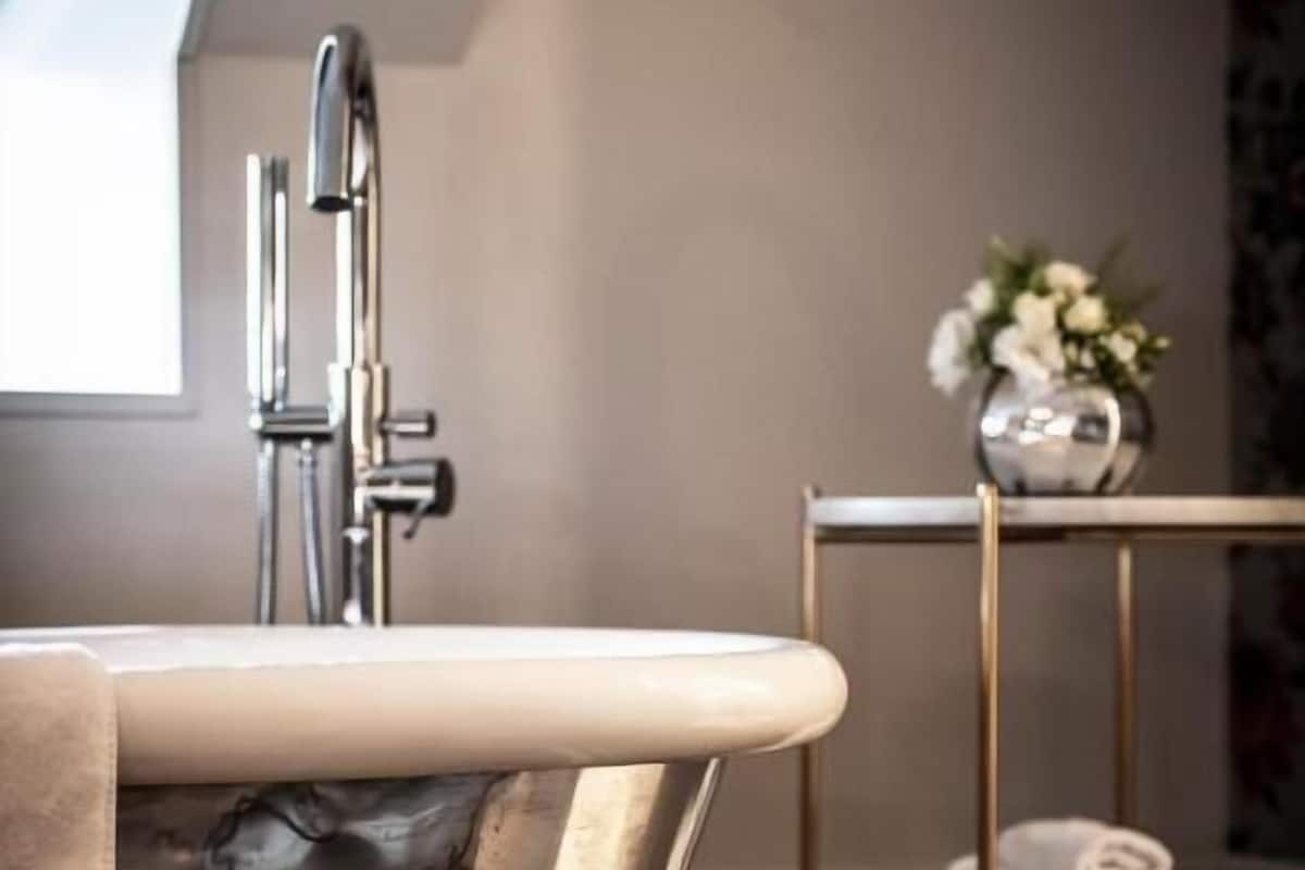 Bathroom | Combined shower/tub, designer toiletries, hair dryer, slippers
