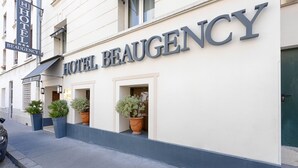 A hotel facade with the name "BEAUGENCY" prominently displayed. There are potted plants on the sidewalk in front of the entrance. - Beaugency Hotel (Paris)