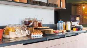 A breakfast buffet with various food items and condiments.