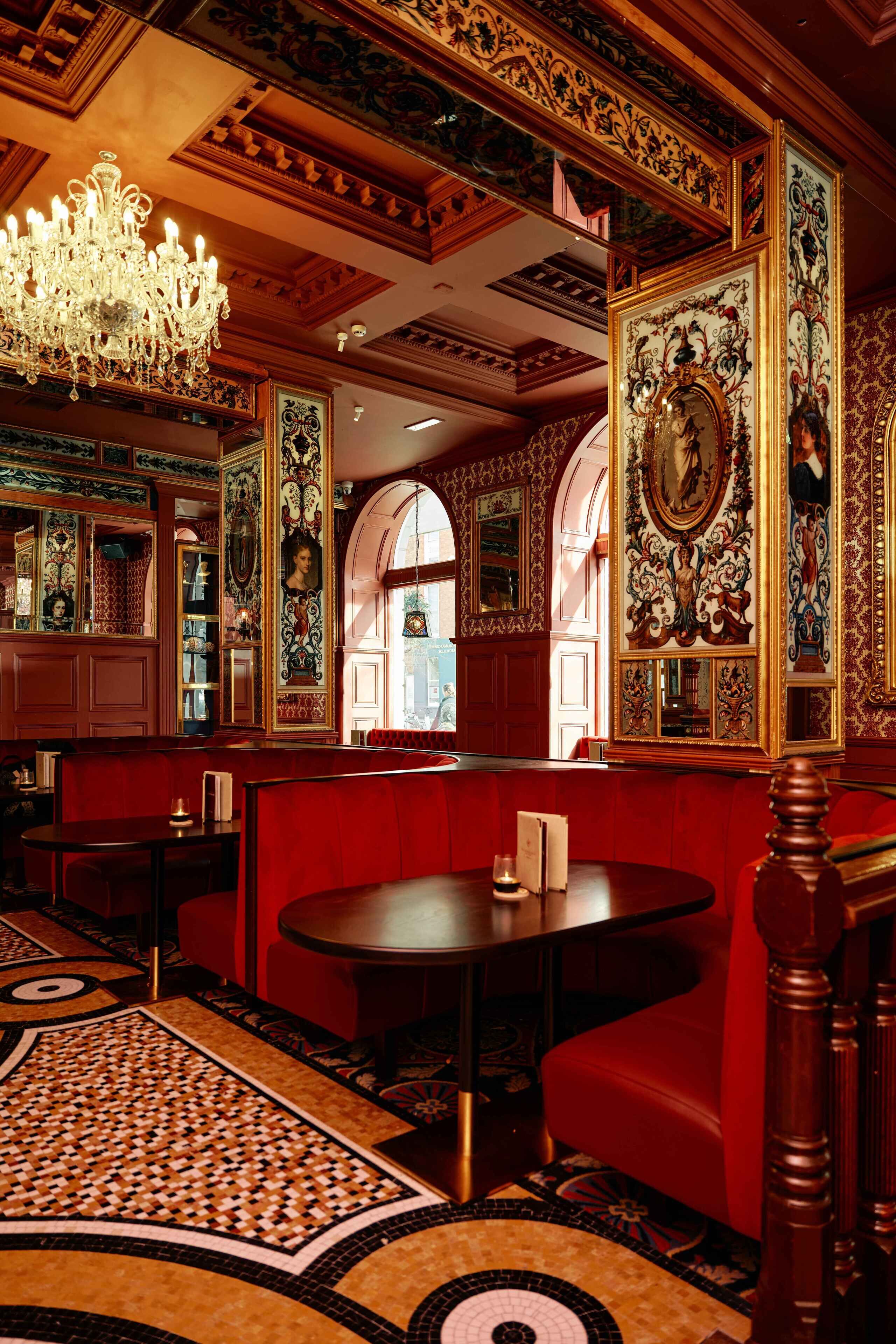 A luxurious interior with ornate decorations, a chandelier, and a patterned floor.
