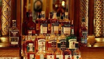 A bar with various bottles of alcohol, including brands like Jameson and Midleton.