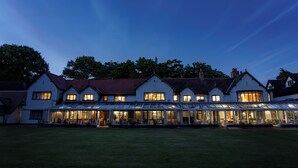 A large, white building with multiple windows and a glass conservatory. -  Macdonald Craxton Wood Hotel & Spa, Chester (Ellesmere Port)
