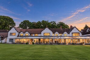 A large, multi-story building with a covered patio area and a well-maintained lawn in front. - Macdonald Craxton Wood Hotel & Spa, Chester (Ellesmere Port)