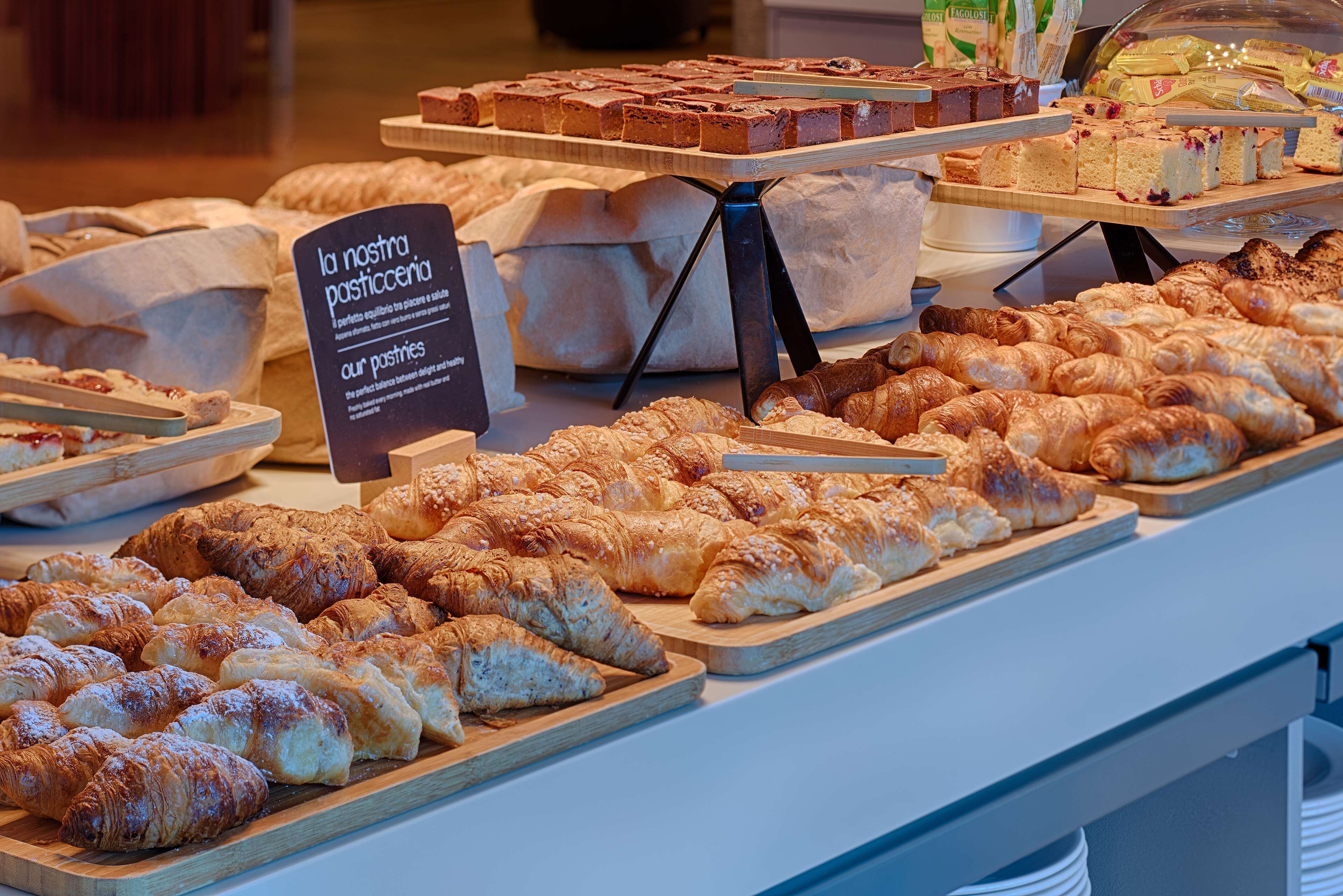 A bakery display with various pastries and breads.