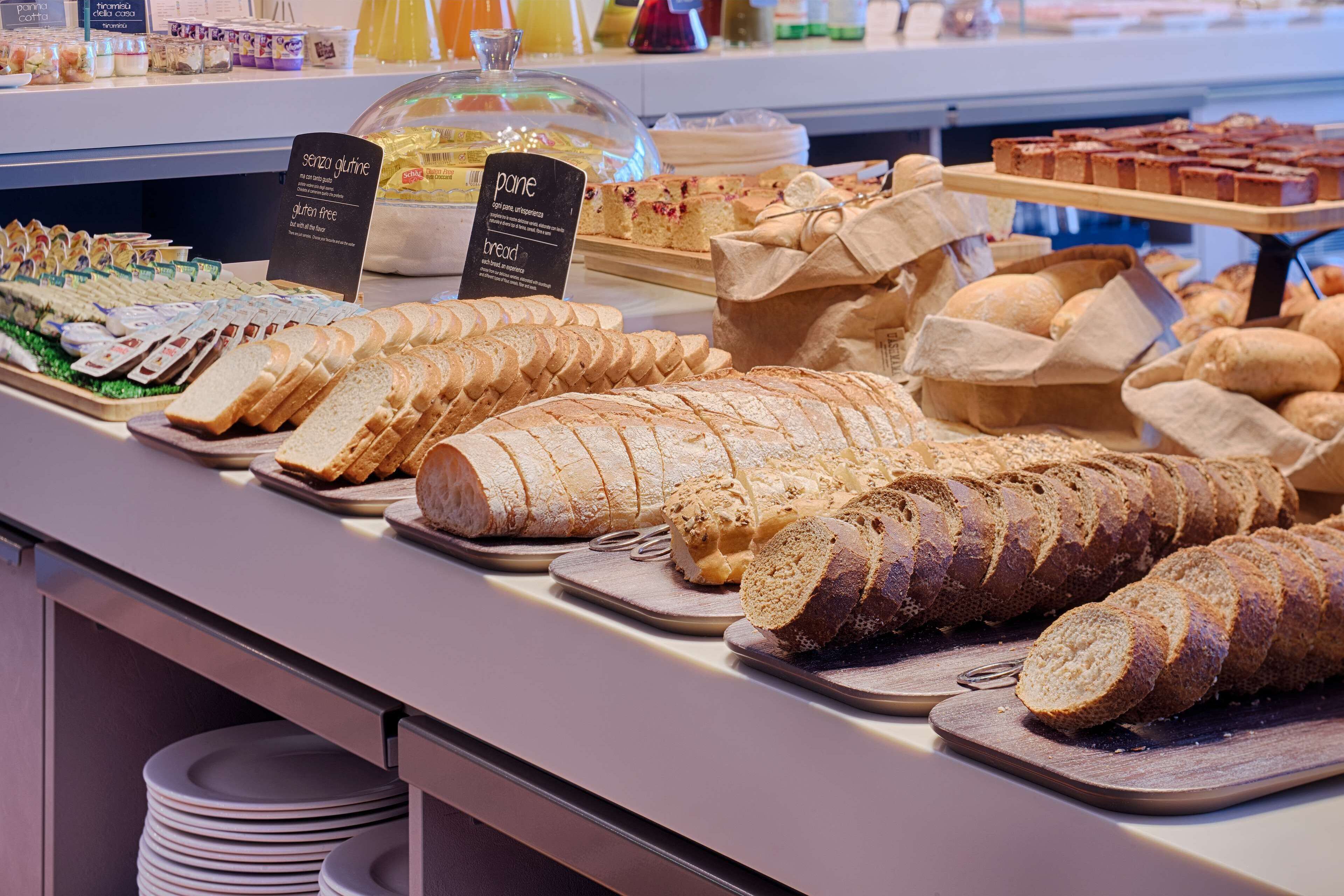 A bakery display with various breads and pastries.