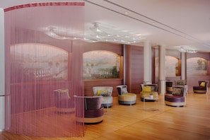 A spacious lobby with modern seating, large windows with mountain views, and a decorative pink curtain. - NH Lecco Pontevecchio (Lecco)
