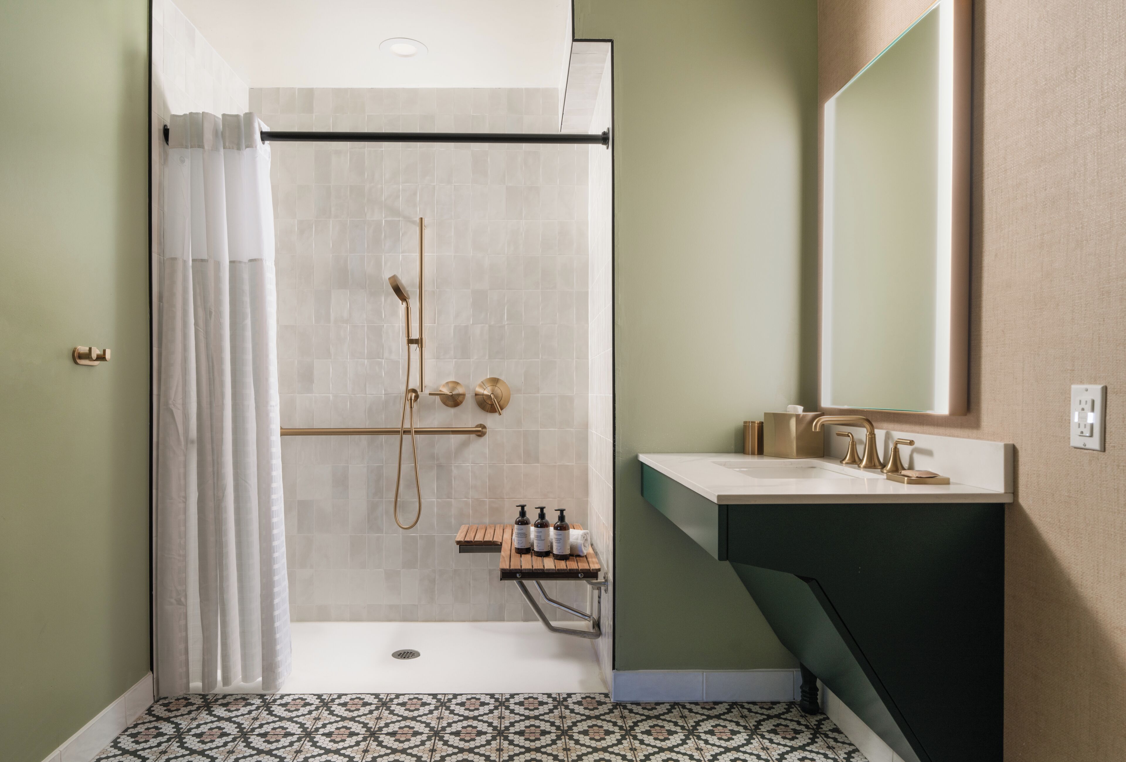 A bathroom with a shower, toilet, and sink.