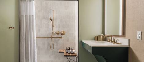 A bathroom with a shower, toilet, and sink.