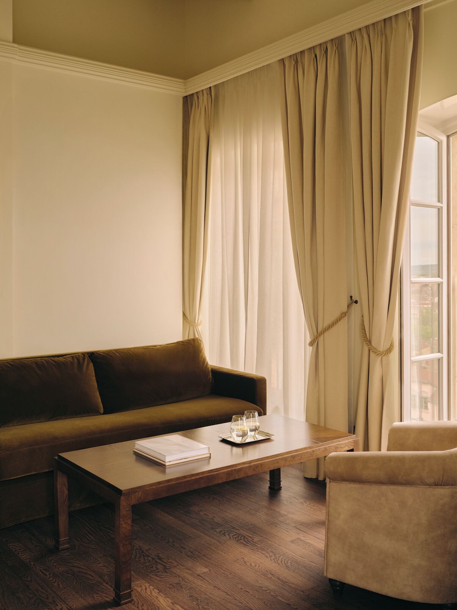 Een woonkamer met een bank, een salontafel en een fauteuil.