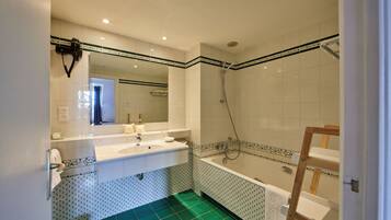 Une salle de bain avec un lavabo, un miroir et une douche.