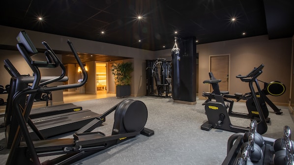 A gym with treadmills, elliptical machines, and weight machines.