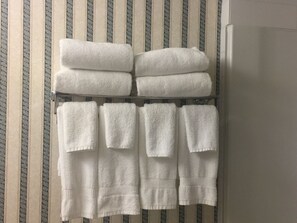 A rack with multiple white towels.
