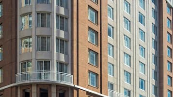 A multi-story hotel with a brick facade, large windows, and a sign reading "COURTYARD".