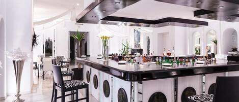 A modern kitchen with a central island, bar area, and seating.