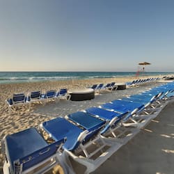 On the beach, white sand, sun-loungers, beach towels
