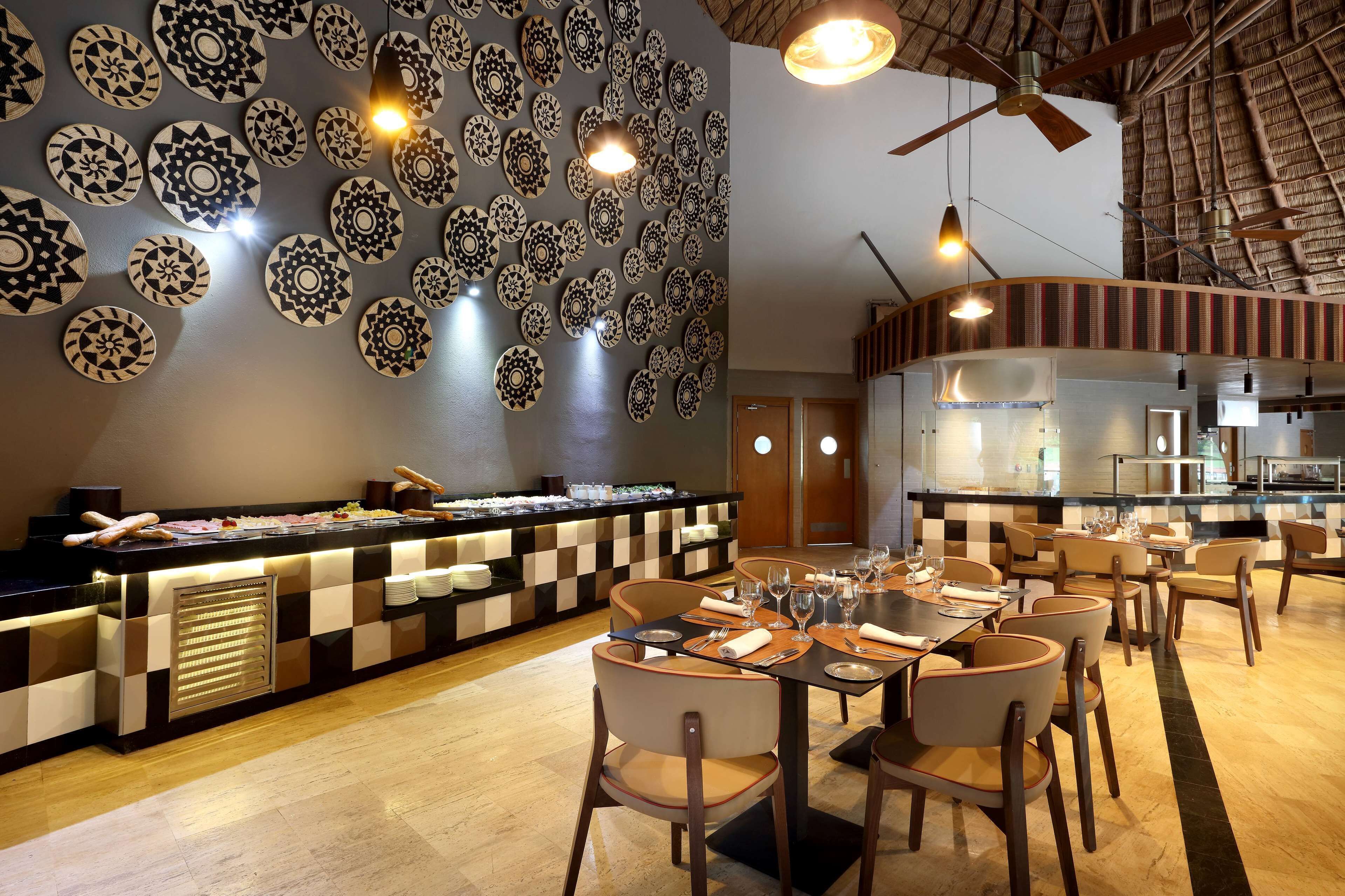 A restaurant with a buffet, checkered wall decor, and a ceiling fan.