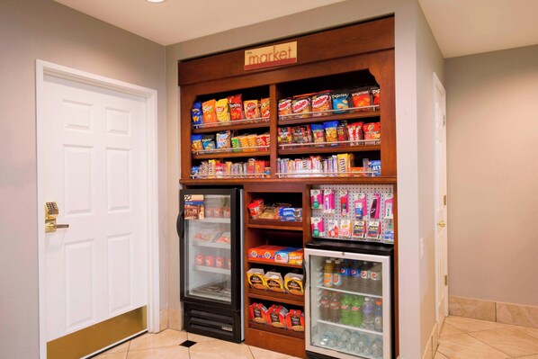 A vending machine area with snacks, drinks, and a refrigerator. - Residence Inn by Marriott Olathe Kansas City (Olathe)