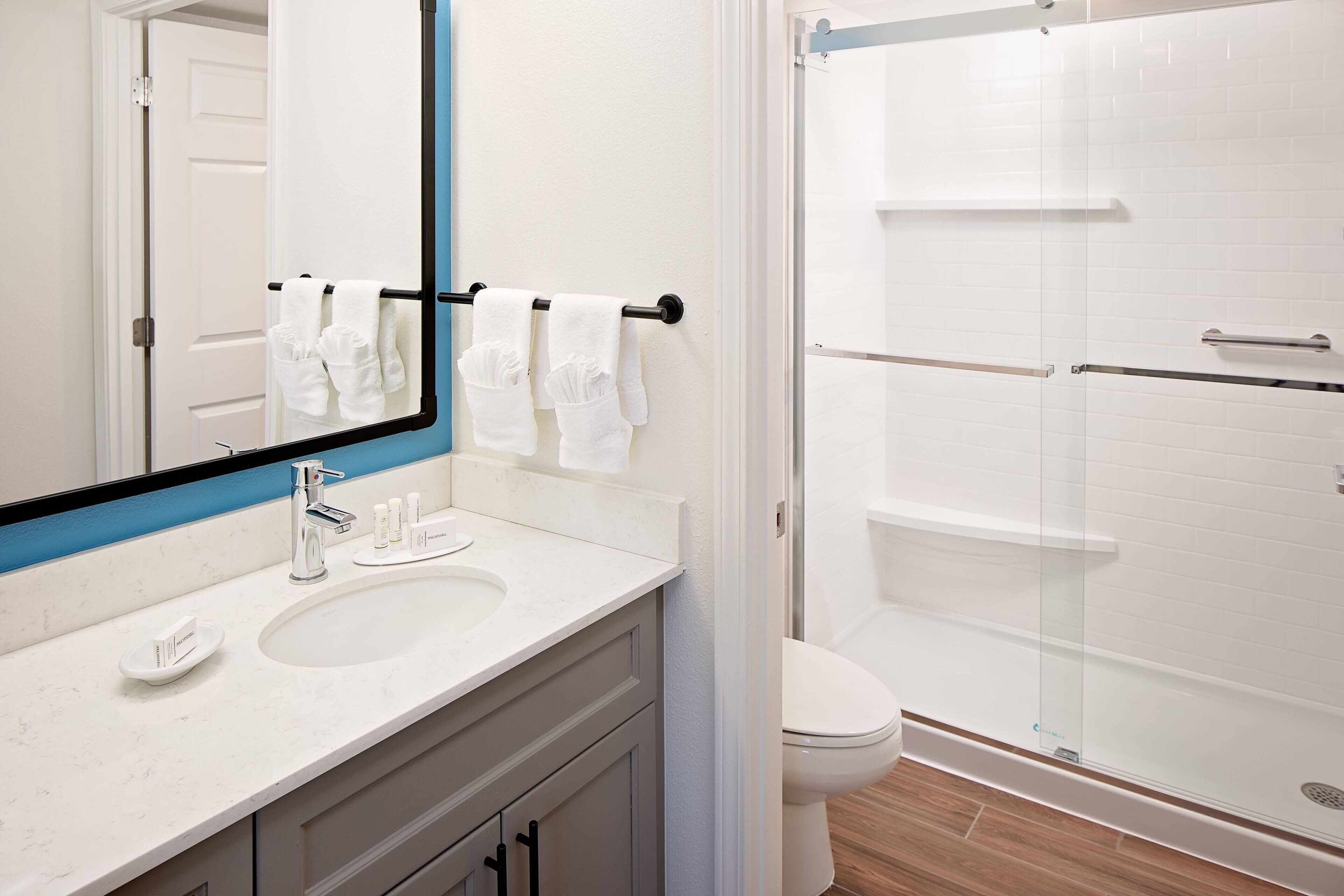 combined shower/bathtub, designer toiletries, hair dryer, towels