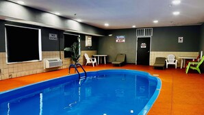 A swimming pool with a no diving sign, a no lifeguard on duty sign, and a no diving sign on the wall. - Baymont by Wyndham Anderson (Anderson)